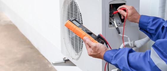 HVAC technician working on an AC unit